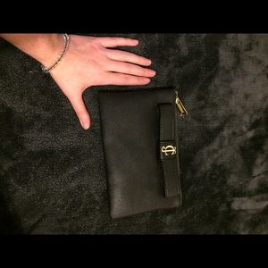 Juicy couture clutch black with gold buckle.